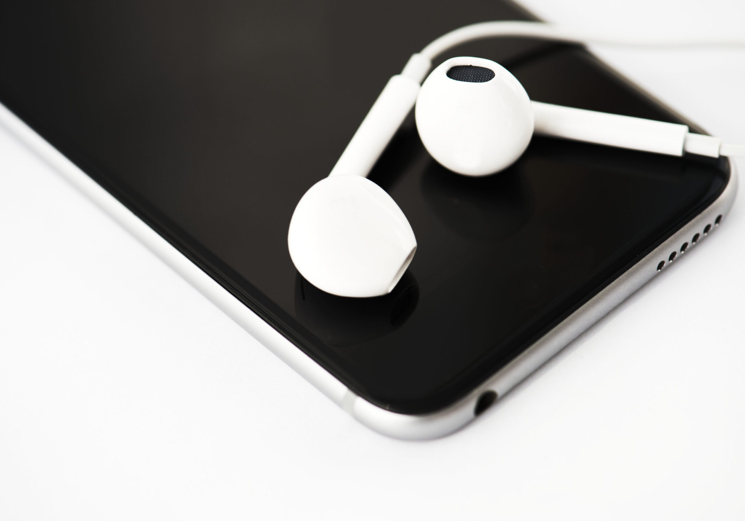 Closeup of mobile phone with earphones